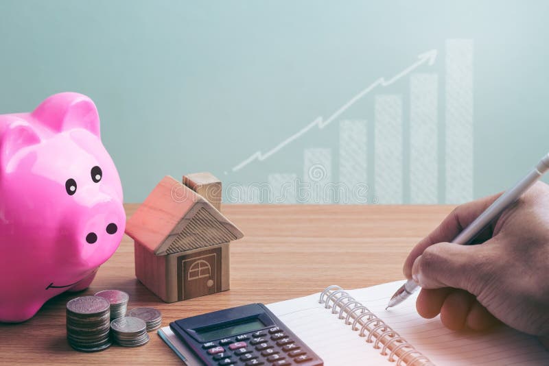 House placed on coins and piggy bank Men`s hand is planning savings money stock photography House placed on coins and piggy bank Men`s hand is planning savings money stock photography