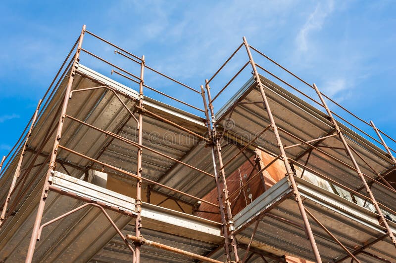 House for Renovation with the Scaffolding for Bricklayers Stock Image