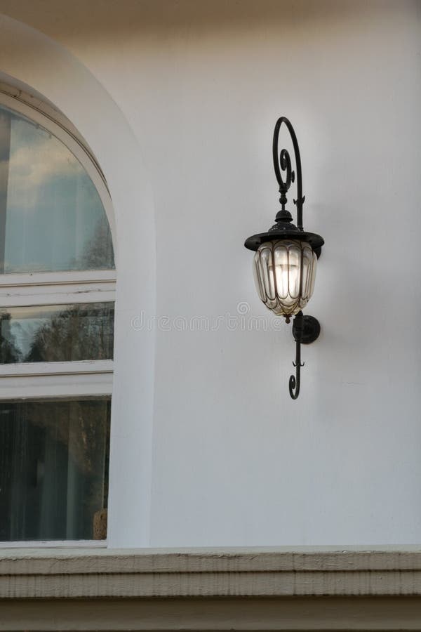 House Window and Vintage Lighting Fixture Attached on Wall Stock Image