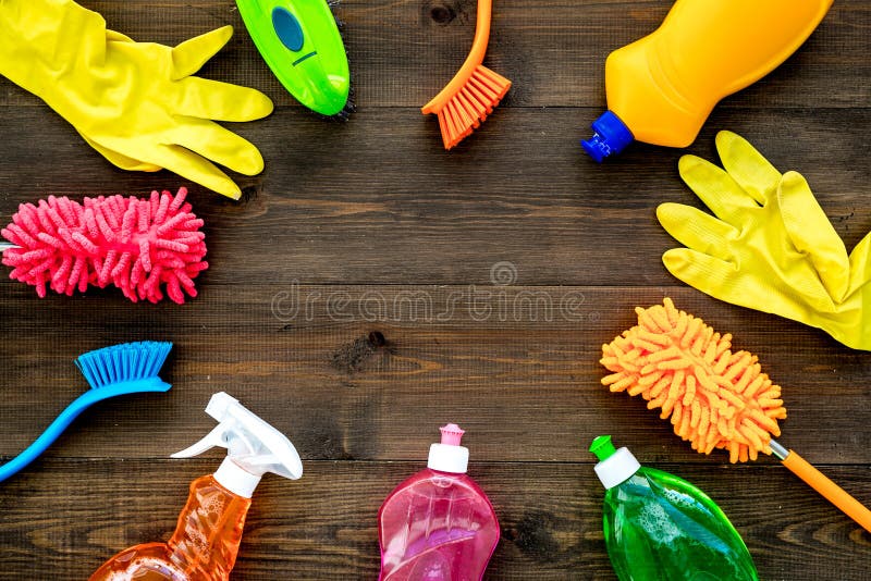 Housecleaning with detergents, soap, cleaners and brush in plastic bottles on wooden desk background top view mockup. Housecleaning with detergents, soap, cleaners and brush in plastic bottles on wooden desk background top view mockup