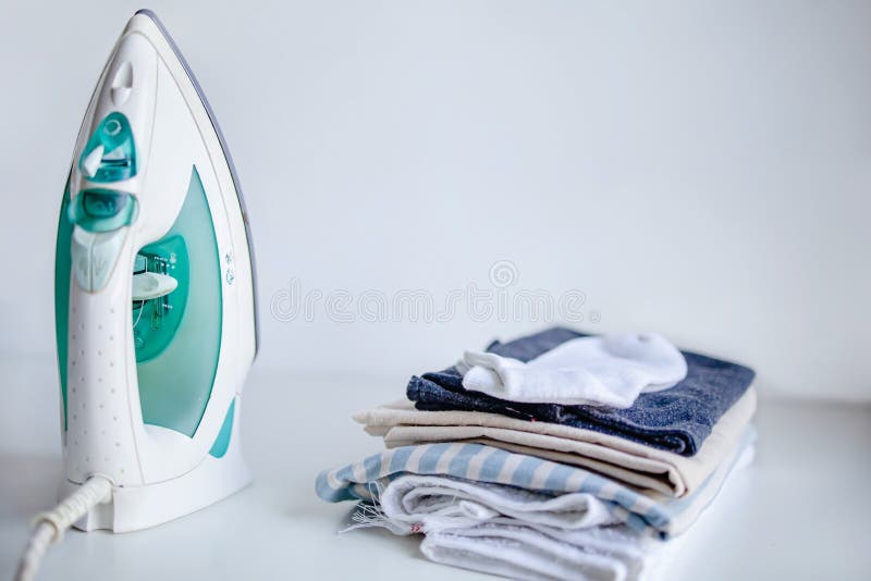 Household Laundry Ironing. Iron on Table on White Background, Copy
