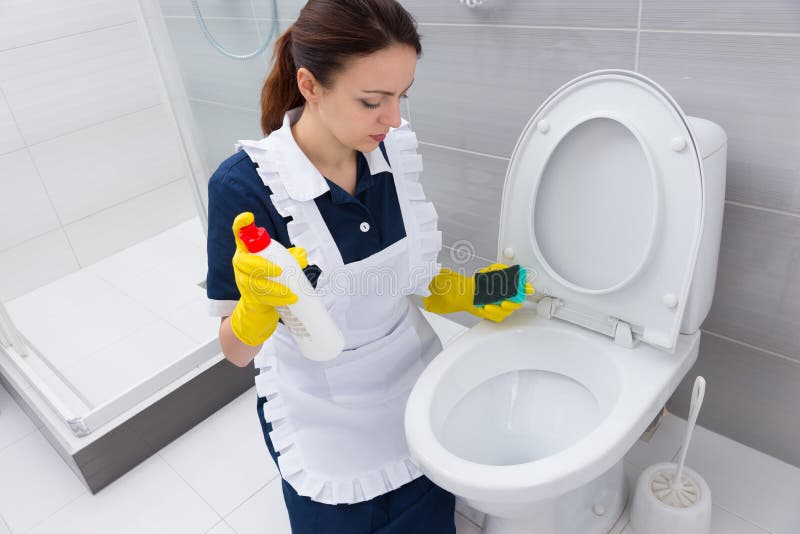 Housekeeper With Sponge And Cleaner At Toilet Stock Image 