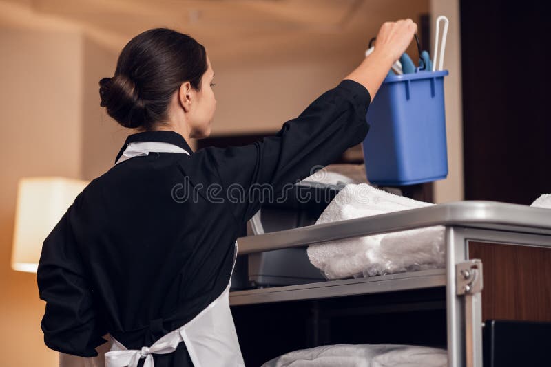 A Housekeeping Lady in a Uniform Cleaning the Room Stock Photo Image