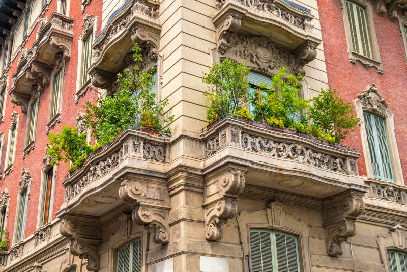 Houses with Flowers on the Windows in Milan, Italy Stock Photo Image