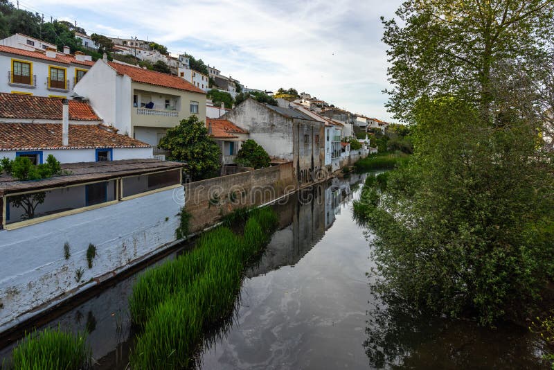 Houses reflecting in a river in the small town Aljezur, Algarve, Portugal