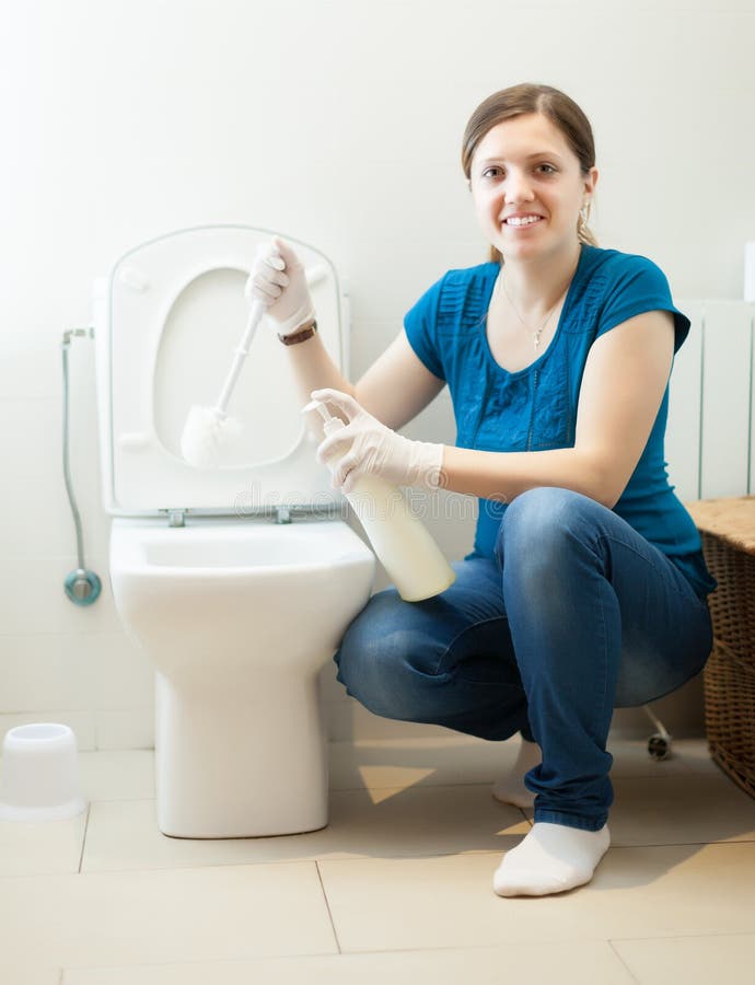 Housewife cleaning toilet bowl with brush stock image Housewife cleaning toilet bowl with brush stock image