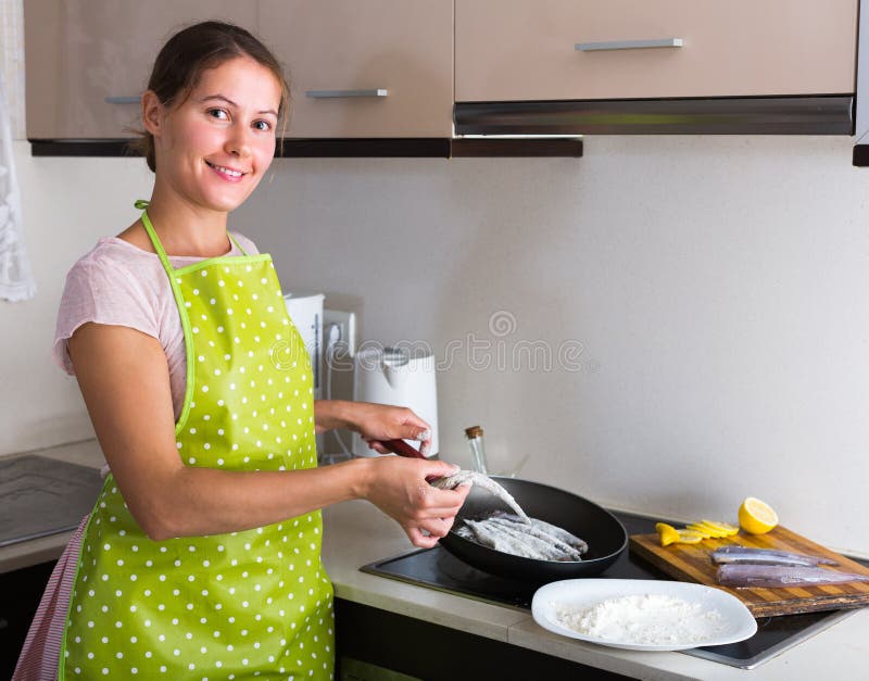 Housewife Frying Fish At Kitchen Stock Image Imag