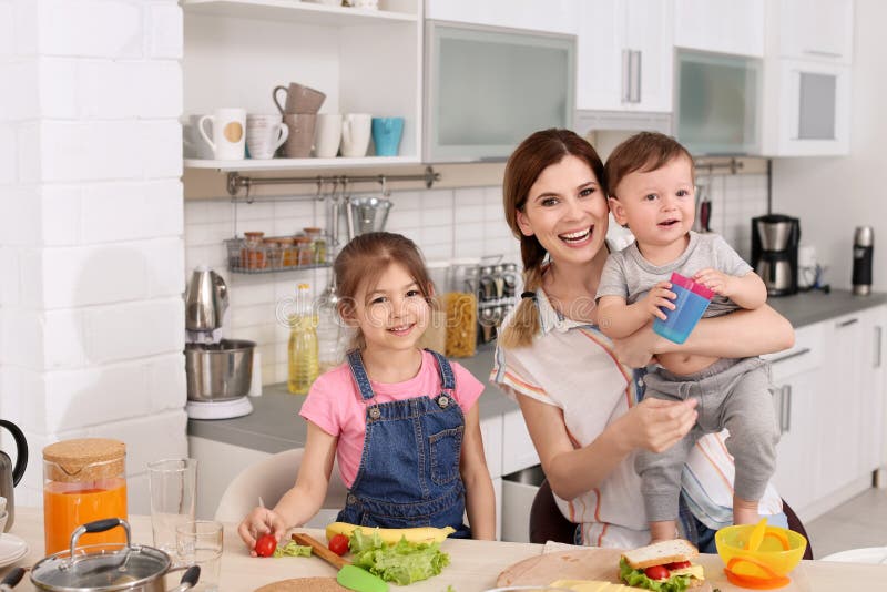 Housewife Preparing Dinner with Her Children on Kitchen Stock Photo ...