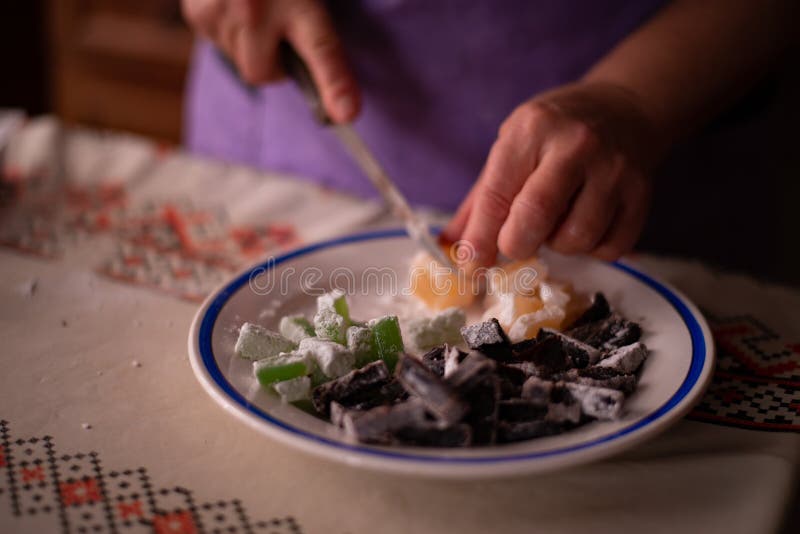 Housewife Slicing Turkish Delicacies into Small Cubes on a Plate St