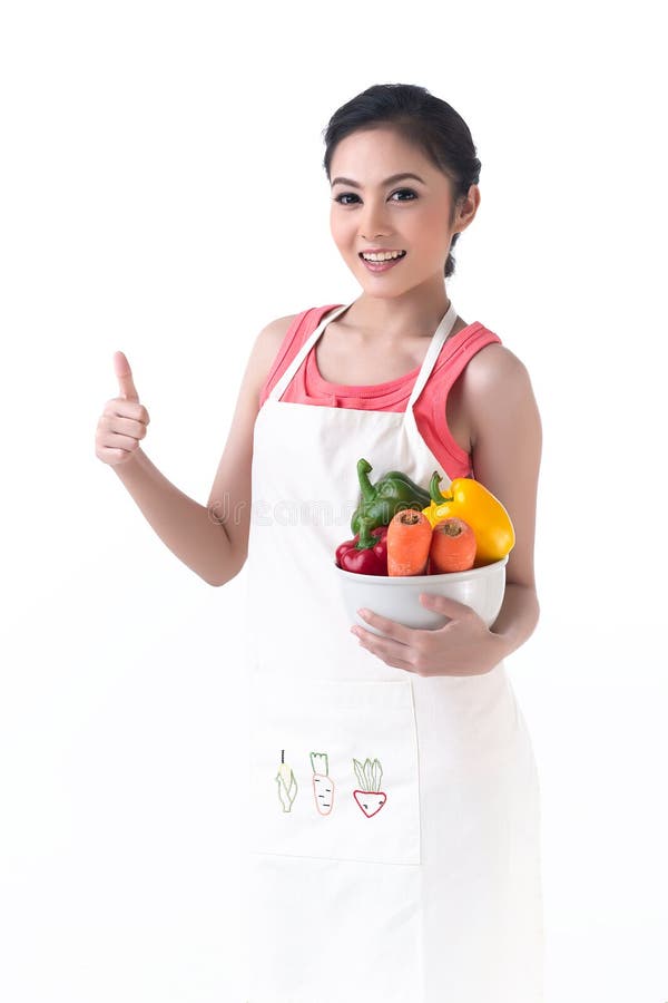 A housewife thump up and hold a bowl of vegetables