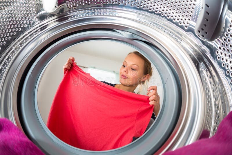 Housework: young woman doing laundry royalty free stock images