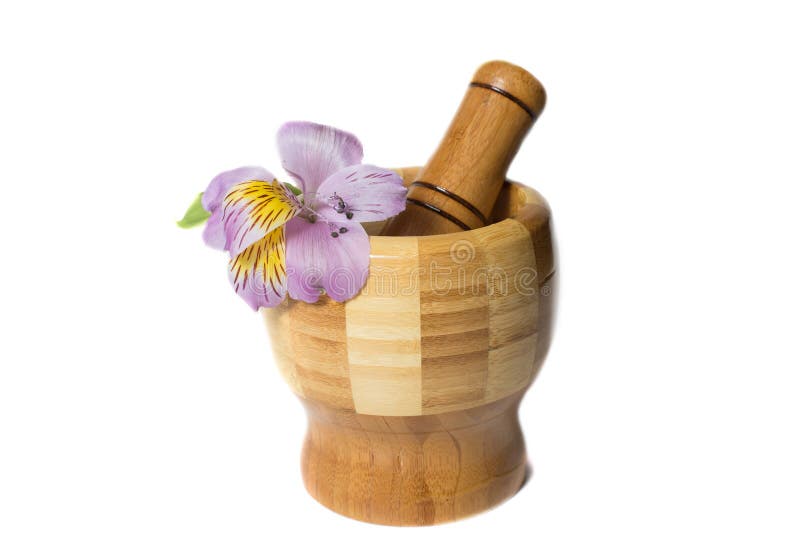 Wooden bamboo pounder with magenta flower isolated. Wooden bamboo pounder with magenta flower isolated