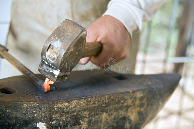 Blacksmith working metal with hammer and anvil. Blacksmith working metal with hammer and anvil