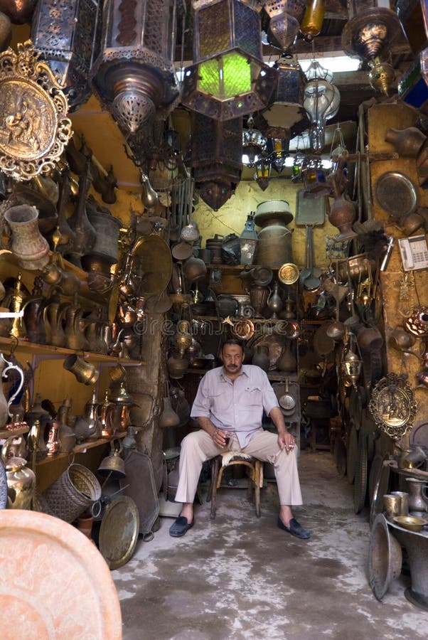 The owner of an ironware store sat in his place waiting for buyer. In this Khan el-Khalili Bazaar in cairo, the potential customer for these traditional handiwork can be foreign tourists, while local people are more and more focusing on modern machine products. The owner of an ironware store sat in his place waiting for buyer. In this Khan el-Khalili Bazaar in cairo, the potential customer for these traditional handiwork can be foreign tourists, while local people are more and more focusing on modern machine products.