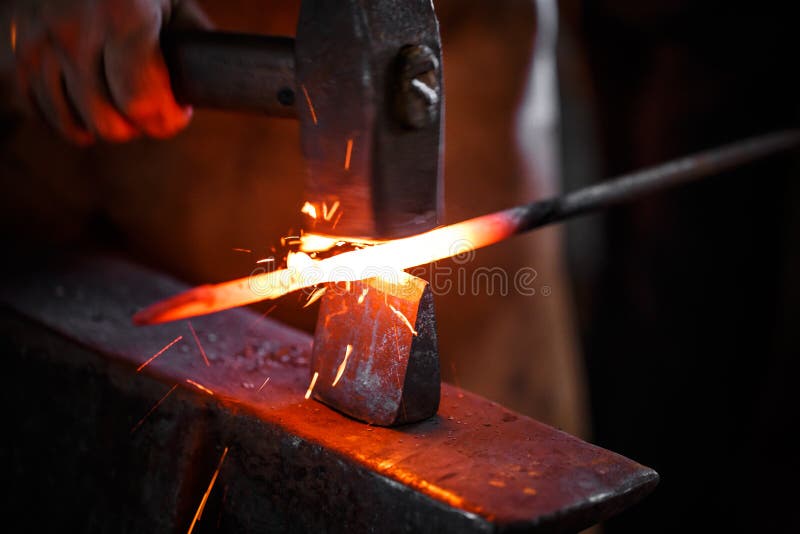 The hands of a blacksmith at work in the smithy. The hands of a blacksmith at work in the smithy