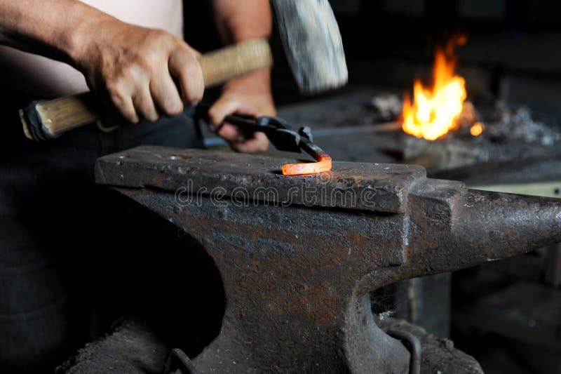 Blacksmith forges iron in the forge. Blacksmith forges iron in the forge