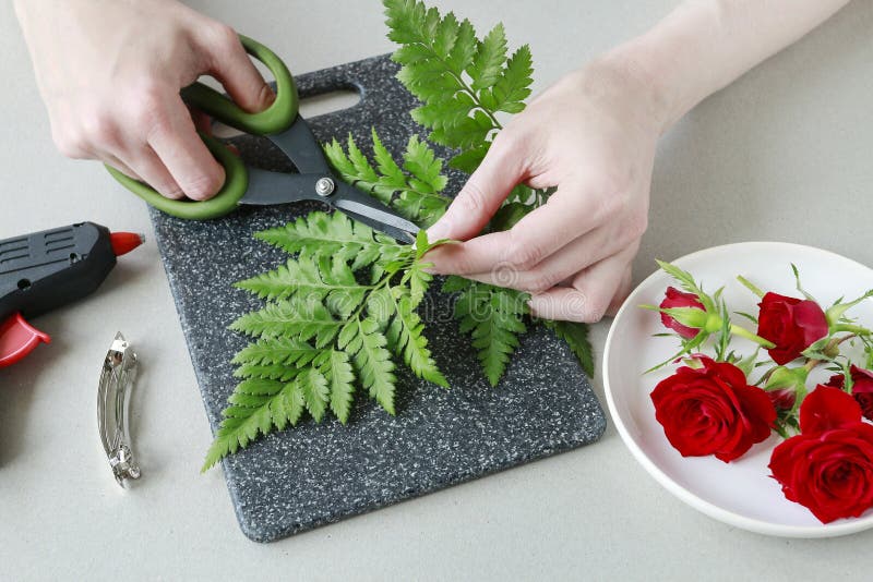 How to make a hair clip with fresh flowers and fern, tutorial royalty free stock photo