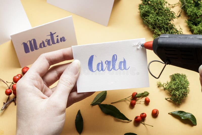 How to make wedding place name cards with handwritten letters and fresh plants stock photo