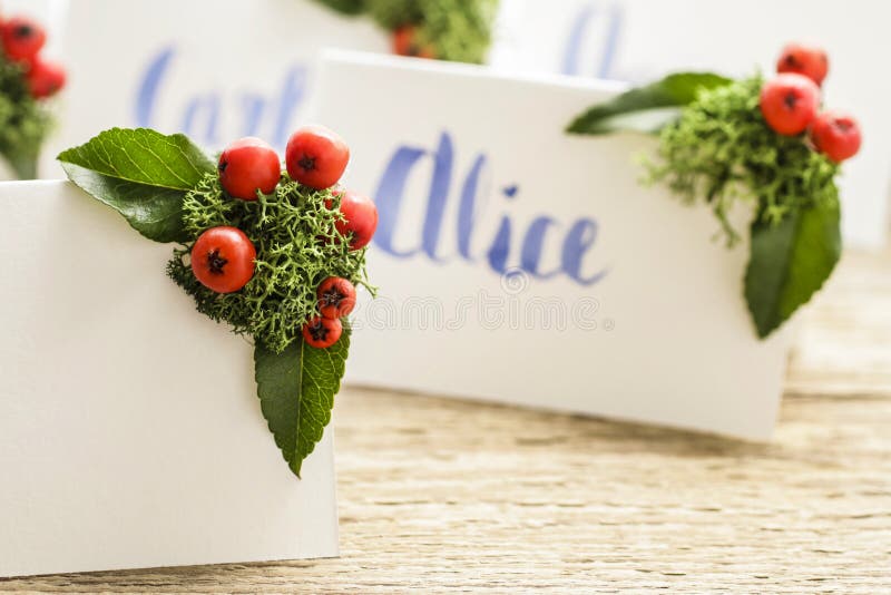 How to make wedding place name cards with handwritten letters and fresh plants stock photos