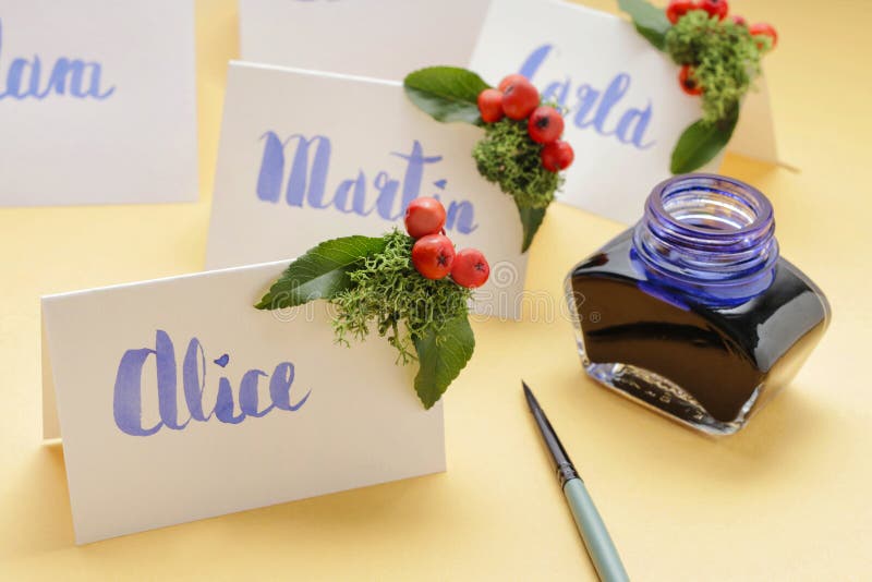 How to make wedding place name cards with handwritten letters and fresh plants royalty free stock photo