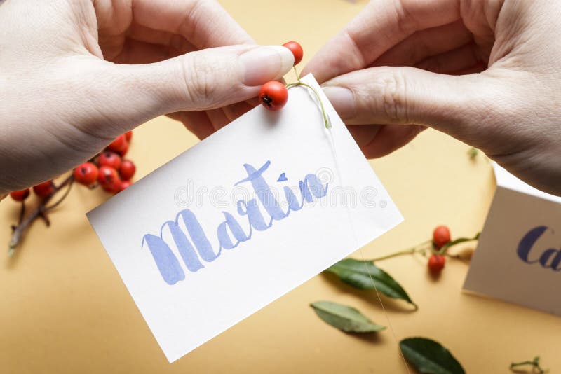 How to make wedding place name cards with handwritten letters and fresh plants royalty free stock photos