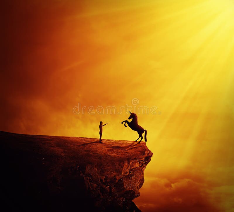 Idyllic view with a boy standing at the edge of a cliff chasm trying to tame a wild unicorn. Begining of a new friendship, fearless symbol. Idyllic view with a boy standing at the edge of a cliff chasm trying to tame a wild unicorn. Begining of a new friendship, fearless symbol