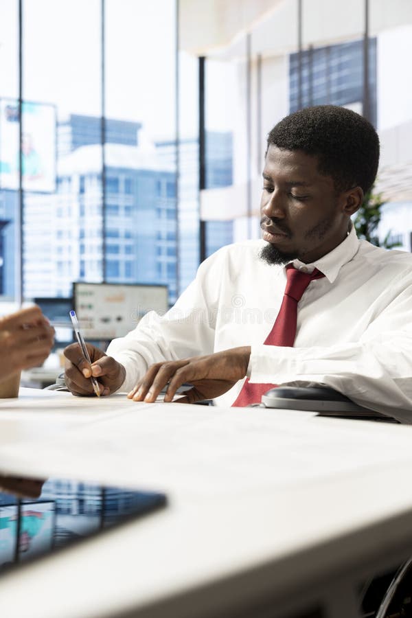 Headhunter at office desk verifying resume before agreeing terms with candidate stock photo