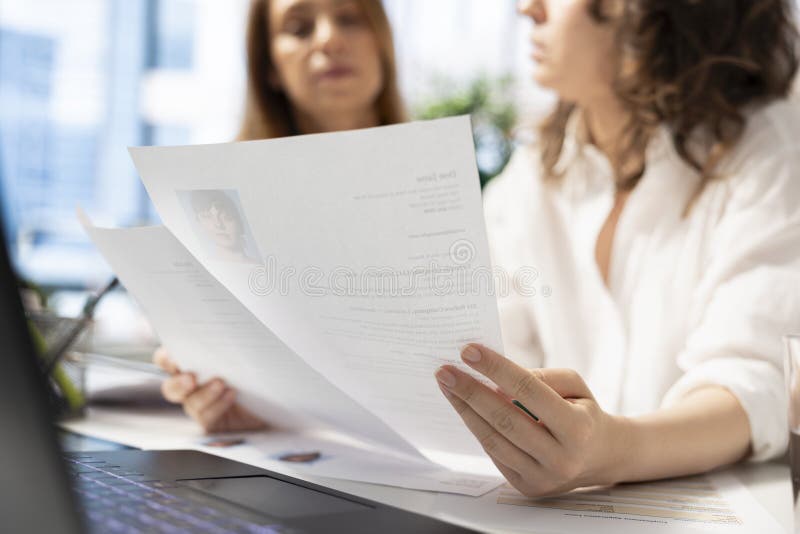 HR staff members analyzing candidates resumes in office stock image