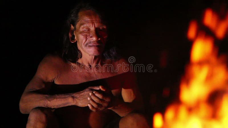Huaorani Hunter Resting By The Fire