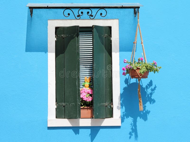 Colorful facade with window with shutters, typical vivid colors for village Burano on venetian lagoon, Italy, Europe. Colorful facade with window with shutters, typical vivid colors for village Burano on venetian lagoon, Italy, Europe