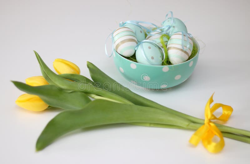 Huevos de Pascua y tulipanes amarillos fotografía de archivo Huevos de Pascua y tulipanes amarillos fotografía de archivo