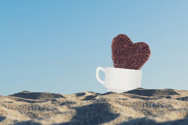 https://thumbs.dreamstime.com/b/huge-cookie-ground-coffee-form-heart-coffee-cup-sandy-beach-huge-cookie-ground-coffee-123249070.jpg