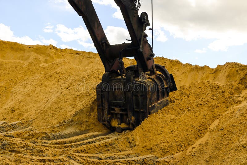 Huge Excavator Bucket Digs Sand in Sand Quarry Mining Stock Image