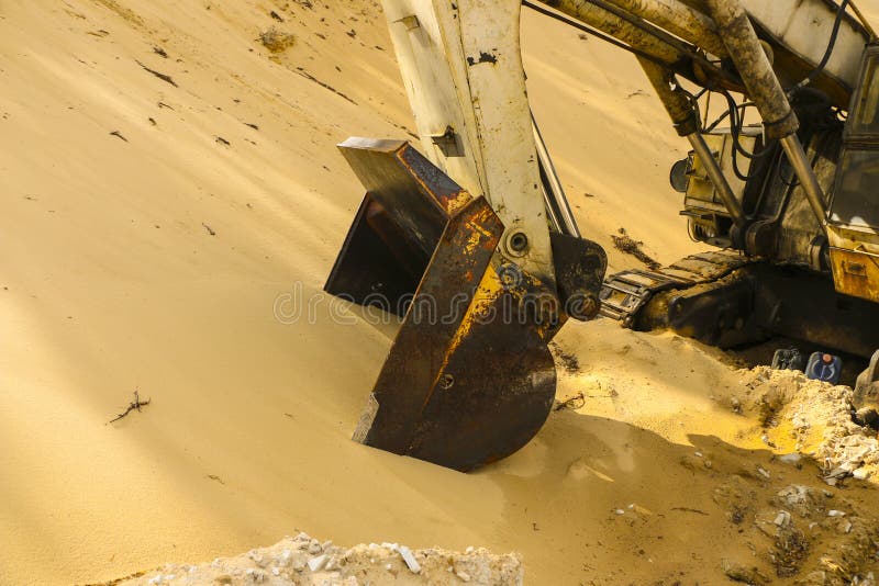 Huge Excavator Bucket Digs Sand in Sand Quarry Mining Stock Photo