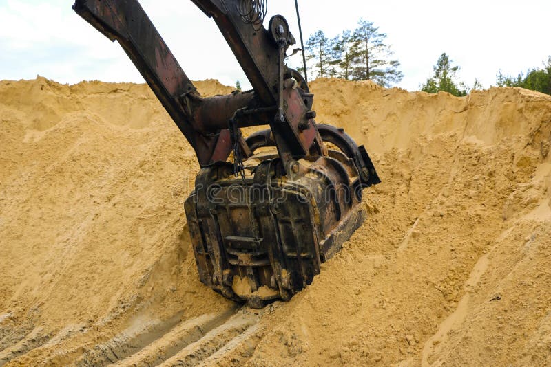 Huge Excavator Bucket Digs Sand in Sand Quarry Mining Stock Image