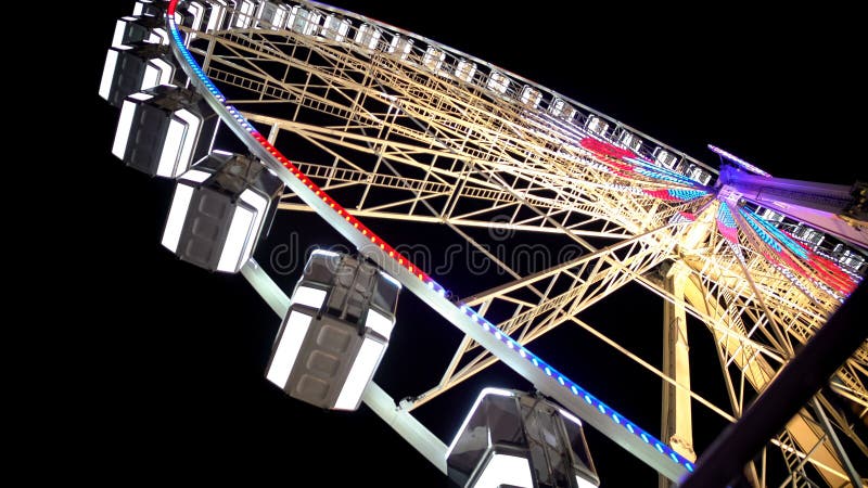 Huge Ferris wheel with illuminated passenger cars, amusement ride in Paris royalty free stock photos Huge Ferris wheel with illuminated passenger cars, amusement ride in Paris royalty free stock photos