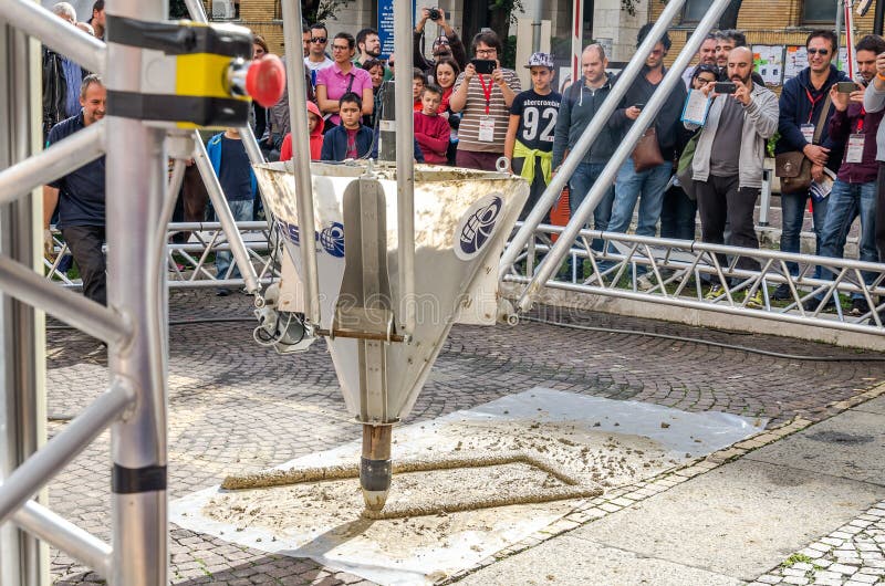 ROMA, ITALY - OCTOBER 2015: Huge industrial 3D printer builds a building made of cement automatically without the help of people guided by computer programs