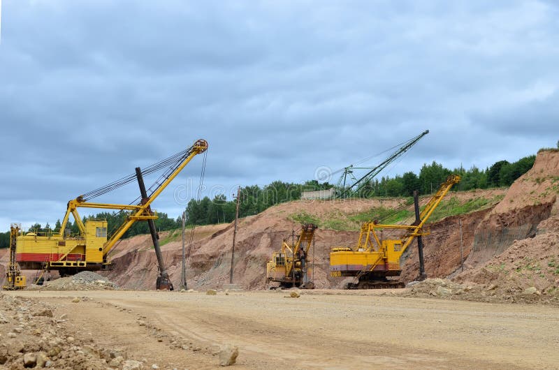 Huge mining excavator in the limestone open-pit. Biggests digger working in dolomite quarry. Largest tracked machine with electric royalty free stock photos