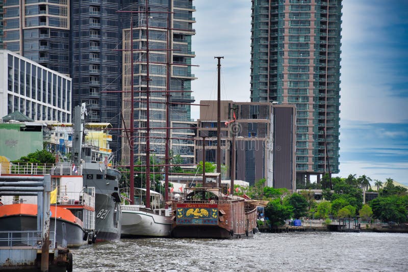 Huge modern and old-style wooden sailing boats, vessels parking in the piers of the Chao Phraya River stock photos Huge modern and old-style wooden sailing boats, vessels parking in the piers of the Chao Phraya River stock photos