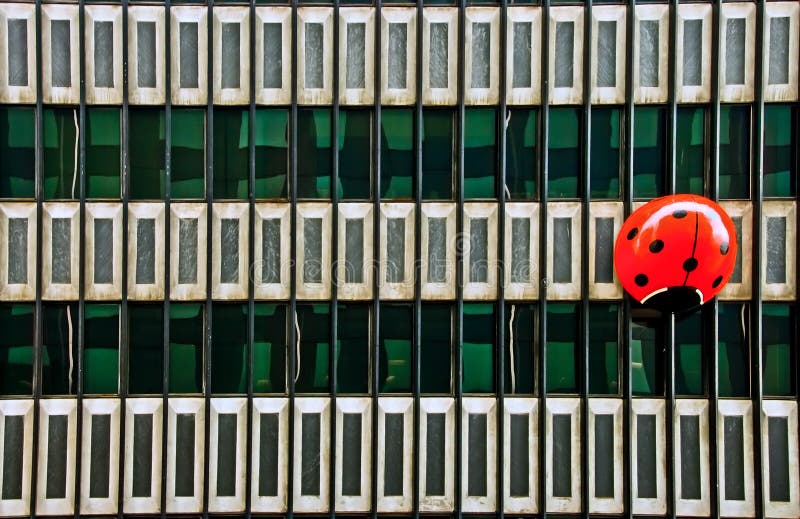 Huge red ladybug on a building facade