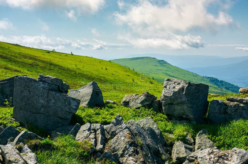 Huge rocky formations on the grassy hills. beautiful mountain landscape in late summer on a cloudy day. location Runa mountain, Ukraine. Huge rocky formations on the grassy hills. beautiful mountain landscape in late summer on a cloudy day. location Runa mountain, Ukraine