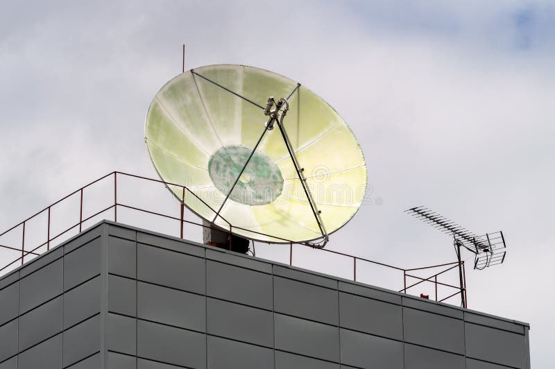 huge satellite dish on the roof of the building. High quality photo