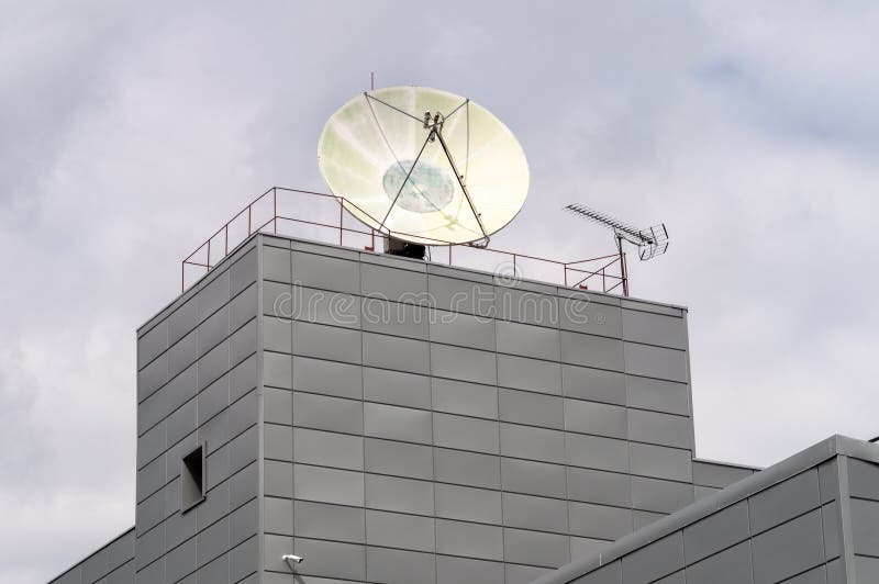 huge satellite dish on the roof of the building. High quality photo