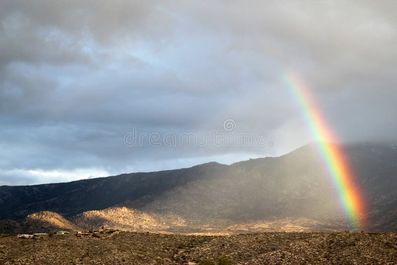 Rainbow with a shaft of shining light over the desert mountains. Desert mountain landscape. Tuscon, Arizona. Horiaontal view. Santa Catalina mountains. Personal rainbow. tiny rainbow. Southwestern rainbow. Rainbow landscape. Rainbow mountains. Rainbow with a shaft of shining light over the desert mountains. Desert mountain landscape. Tuscon, Arizona. Horiaontal view. Santa Catalina mountains. Personal rainbow. tiny rainbow. Southwestern rainbow. Rainbow landscape. Rainbow mountains.