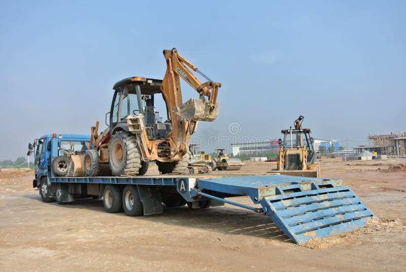 Huge trailer lorry used to mobilize the excavator machine. stock image Huge trailer lorry used to mobilize the excavator machine. stock image