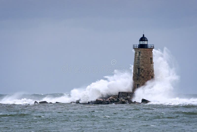 Huge Waves Crashing Around Stone Lighthouse Tower in Maine