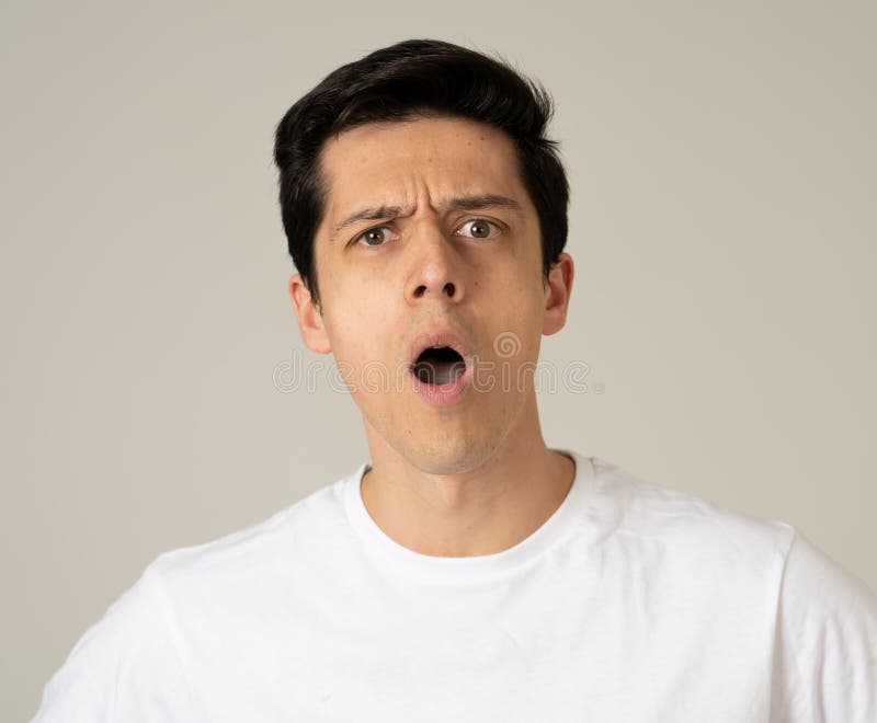 Close up portrait of a handsome caucasian young man with a surprised and shocked face. Attractive male looking amazed with wide eyes and mouth open in surprise. Human facial expressions and emotions. Close up portrait of a handsome caucasian young man with a surprised and shocked face. Attractive male looking amazed with wide eyes and mouth open in surprise. Human facial expressions and emotions