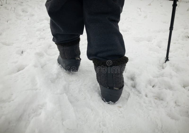 Human Feet Wearing Felt Boots in Rubbers Walking on Snow Stock Image ...