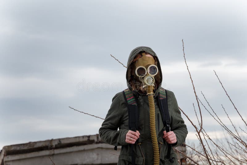 Human in gas mask standing among ruins and dramatic sky background. Enviromental pollution, ecology disaster, radiation, biological hazard concept stock images Human in gas mask standing among ruins and dramatic sky background. Enviromental pollution, ecology disaster, radiation, biological hazard concept stock images
