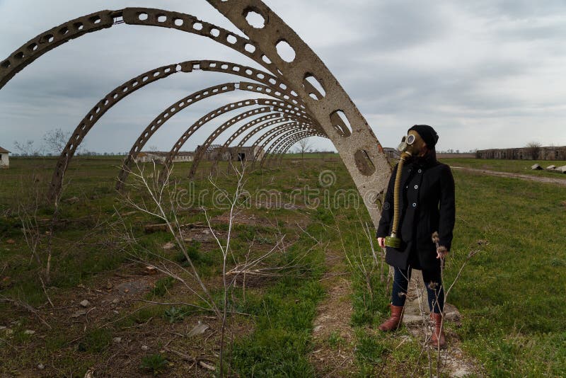 Human in gas mask standing among ruins and dramatic sky background. Enviromental pollution, ecology disaster, radiation. Biological hazard concept royalty free stock photos Human in gas mask standing among ruins and dramatic sky background. Enviromental pollution, ecology disaster, radiation. Biological hazard concept royalty free stock photos